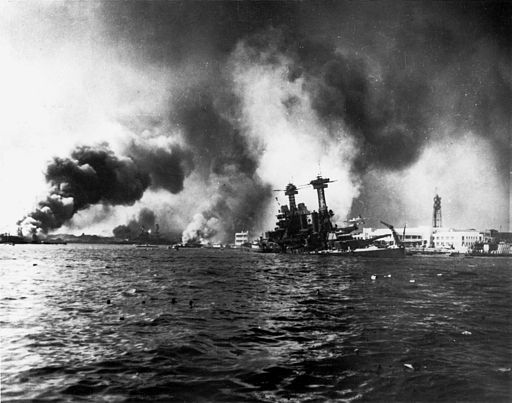a battleship sinking amidst clouds of smoke