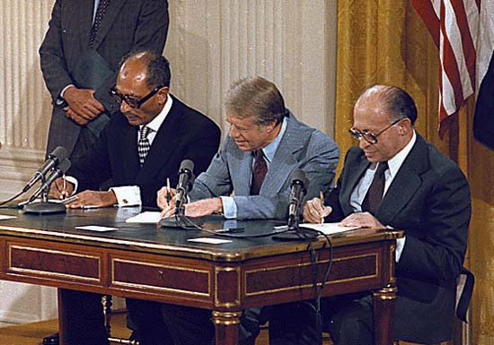 U.S. President Jimmy Carter, Israeli Prime Minister Menachem Begin and Egyptian President. Anwar el-Sādāt signing Camp David Accords.