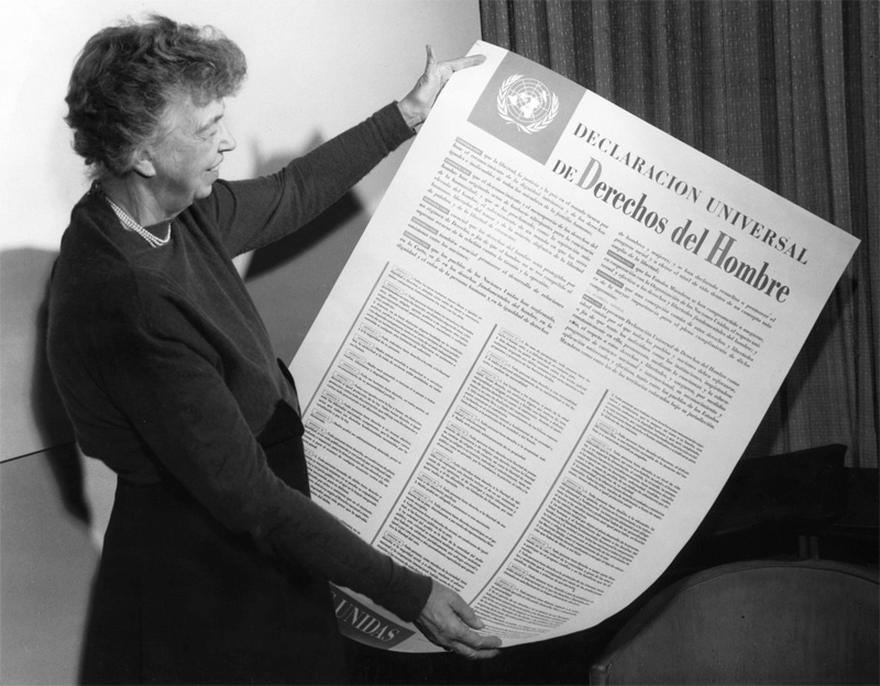Eleanor Roosevelt holding up large version of Universal Declaration of Human Rights