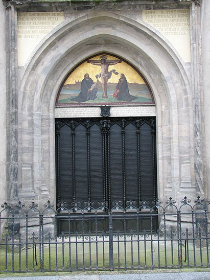 Front door of church behind a gate.